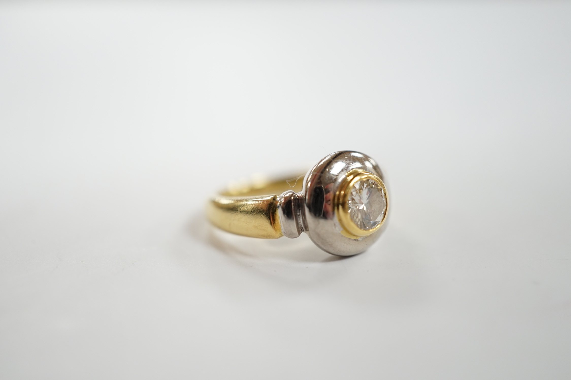 A modern 18ct gold and collet set solitaire diamond ring, with engraving to commemorate the Millenium Dome, the stone weighing 0.40ct, size J, gross weight 6.7 grams.